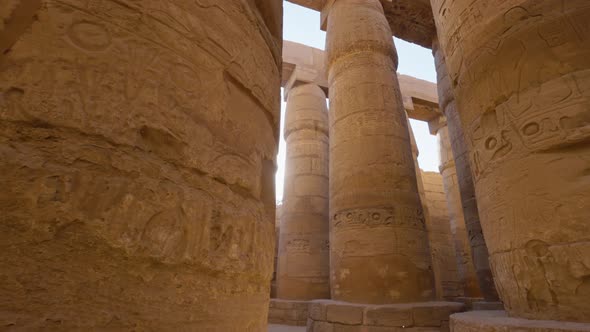 Majestic Columns with Ancient Egyptian Drawings Sun Comes Out From Behind the Column alt