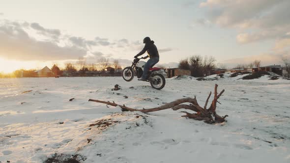 Biker Ride on Bike in the Snow Field Slow Motion alt