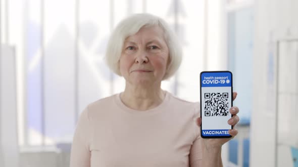 Mature Pensioner Female Person Showing Smartphone in Her Hand with Mobile Application for alt