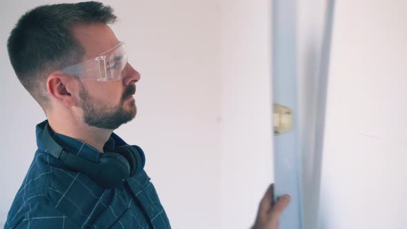 Young Builder Draws Line on Wall and Cries of Disappointment alt