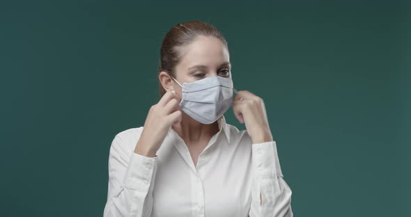 Young woman removing her face mask and feeling relieved, she is breathing and feeling free