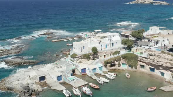 Typical Greek Fishing Village with White Houses and Waves Crashing alt