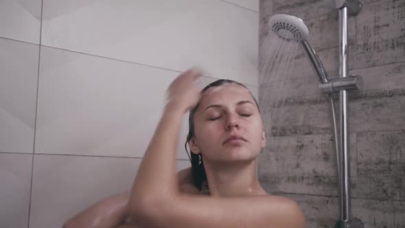 Naked Woman Taking a Shower with Smile on Face alt