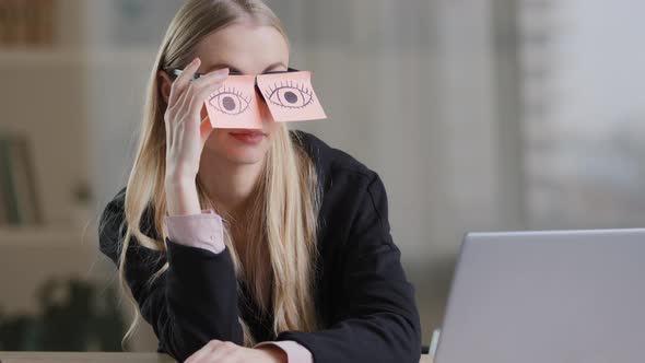 Tired Sleepy Caucasian Woman with Adhesive Notes on Eyes Sticky Notes on Glasses alt