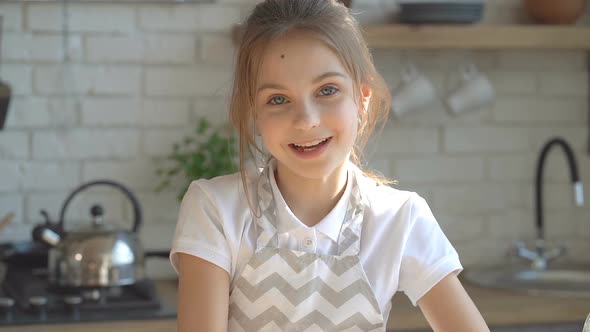 Portrait of Cute Kid Girl at The Kitchen