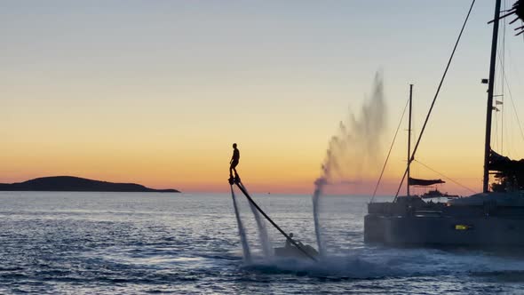 Flyboarding - Silhouette Of Rider Enjoying Flyboard In The Ocean During Golden Hour In Hvar Island, alt