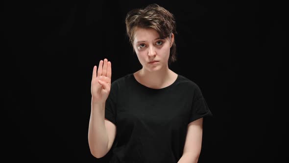 Sad Young Woman Showing Sign to Help Looking at Camera alt