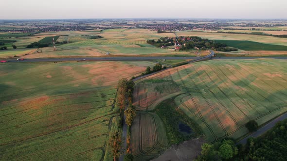 Aerial Drone View of Cars Driving on Highway or Motorway between the Fields