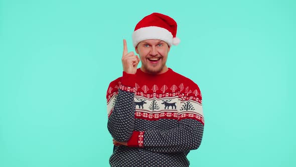 Excited Man in Red Christmas Sweater Make Gesture Raises Finger Came Up with Creative Plan Good Idea alt