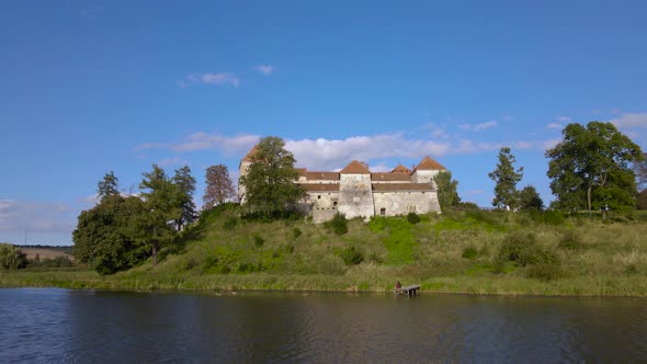 Aerial Drone Shot of Historic Castle on Hill Near Lake Medieval Architecture and Cultural Landmark alt