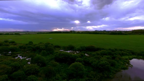Wetlands surrounded by cultivated farmland alt