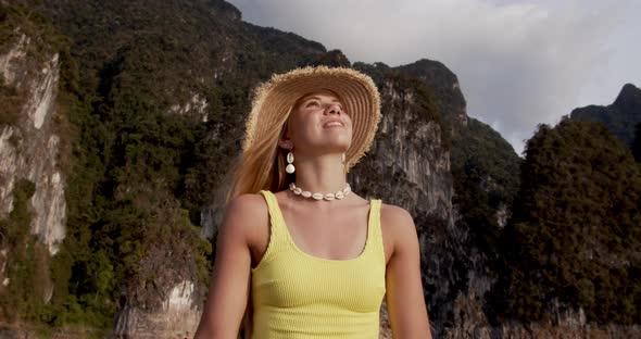 Beautiful Shot of Woman Looking Upwards and Smiling During a Boat Ride alt