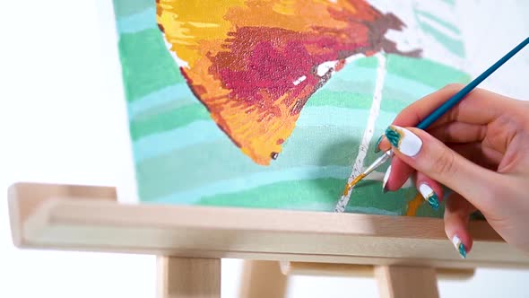 Female Hand With Colorful Nail Art Painting With Small Paintbrush On Canvas. Painting By Numbers. cl alt