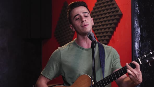 Musician playing guitar and singing in club alt