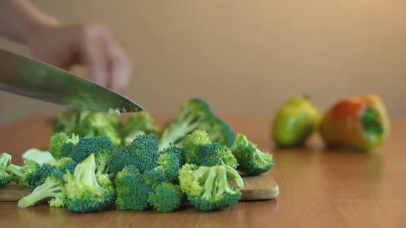 Cutting Broccoli On A Wooden Board