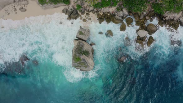 Top Down Aerial View of Azure Water Foaming Ocean Waves Crashing on Wild Beach alt