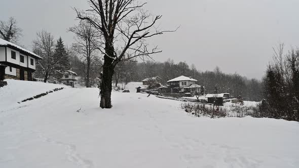 Snow falling over the old beautiful houses