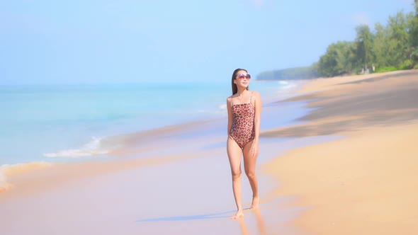 Asian woman enjoy around beautiful beach sea ocean alt