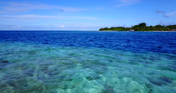 Daytime aerial island view of a sandy white paradise beach and aqua turquoise water background in co alt