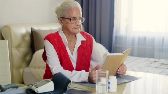 Old Woman Reading a Book at Home