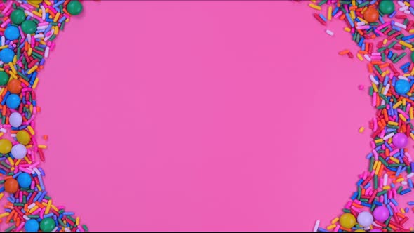 Rotating Pink Background with Candies and Sprinkles with Place for Text or Copy Space alt