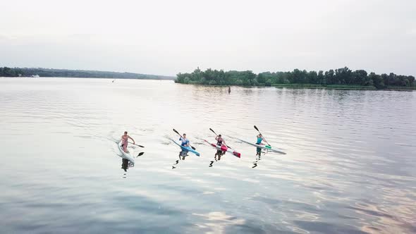 Well-coordinated Team Kayaking on Lake