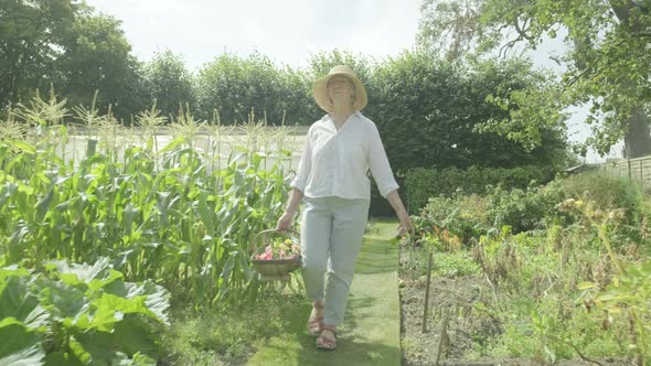 Senior caucasian woman walking through her garden