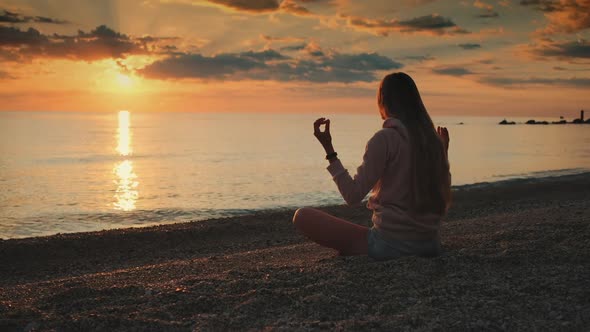 Girl Having Meditation Over the Sea Before Sunset alt