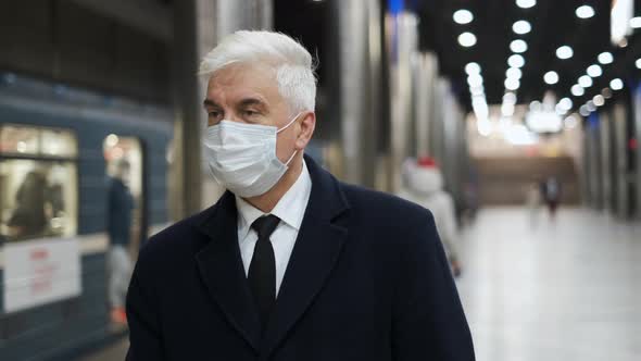 Portrait of Trendy Looking Masked Senior Gentlemen Walking on Metro Station