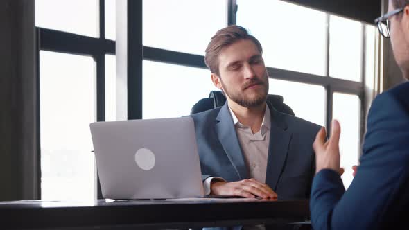 Young boss hiring new colleague shaking hands after successful job interview alt