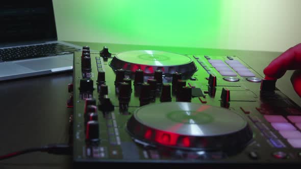 Male DJ Hands Turning Controls And Mixing 20