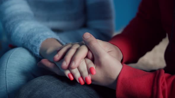 Young man holds the palm of a woman in his, support and care concept, close up alt