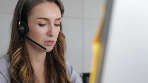 young beautiful women call center wear headset and working with computer while consulting customer alt