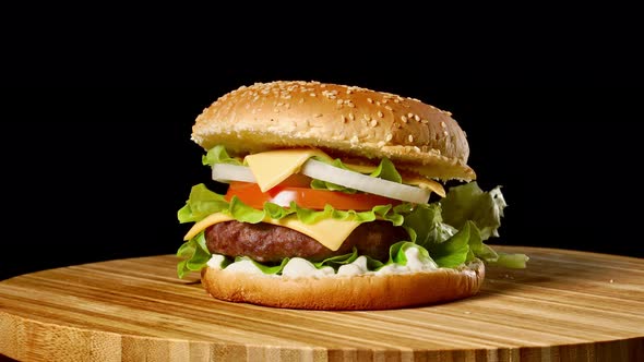 Cheeseburger with Bacon on a Dark Background. Close-up. Macro Shooting alt