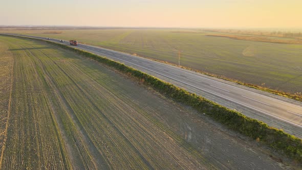 Aerial View of Cargo Truck Driving on Highway Hauling Goods alt