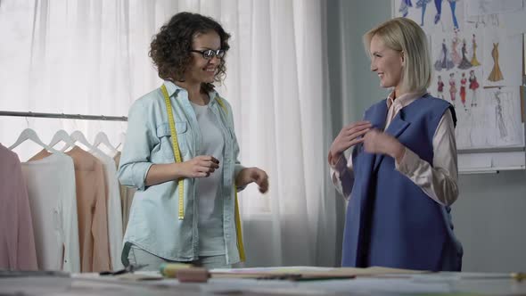 Atelier Owner Listening to Clients Wishes for Decoration of New Coat, Fitting alt