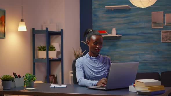 African Freelancer Working From Home Overtime at Laptop alt