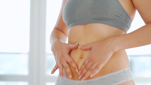 Woman Smears Her Stomach with Stretch Marks Gel and Does Selfmassage alt