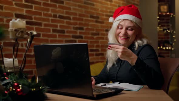 Woman shopping online using laptop on christmas holidays