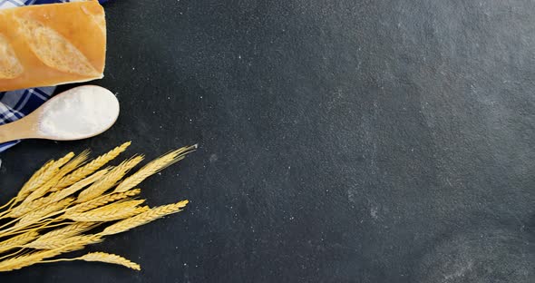 Bread loaf with wheat grains and flour alt