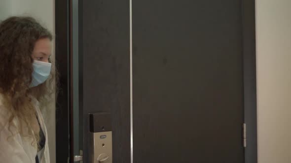 Exhausted Biracial Young Woman Delivery Worker Enters Flat alt