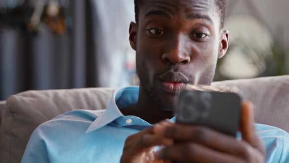 Portrait of african american businessman video chatting with colleague using smartphone alt