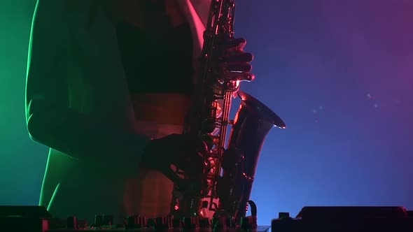 Young Sexy, Blonde Woman Dj in White Jacket and Black Top Playing Music Using Saxophone, Dancing alt
