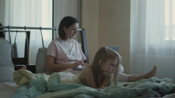 Mom and Daughter Morning in Bed