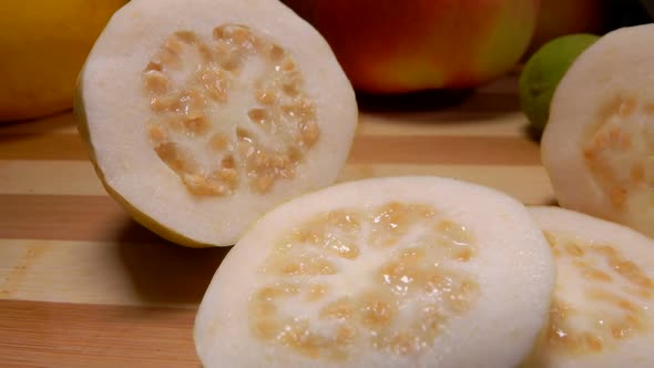 Exotic Guava Slices Are Lying on a Bamboo Board alt