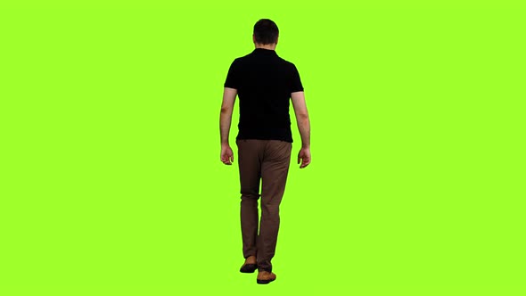 Rear View of Walking Man in Black T-shirt