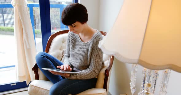 Woman using digital tablet alt