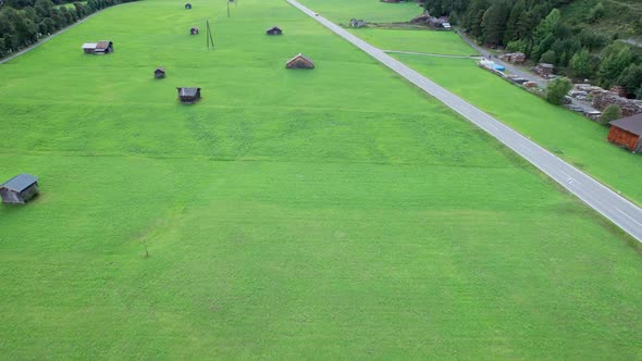 Empty Road in Austrian Valley Between Green Fields in the Alps Aerial View alt