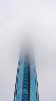 The Spire of Skyscraper in Low Clouds Time Lapse