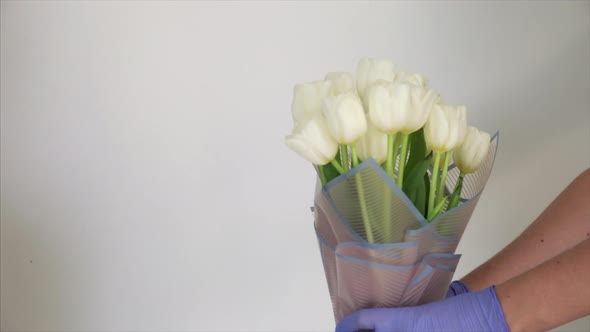 Man Delivers a White Tulips Bouquet To a Girl 